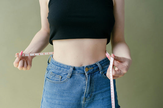 Woman measuring her waist