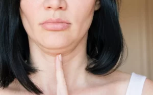 Woman pointing to her double chin