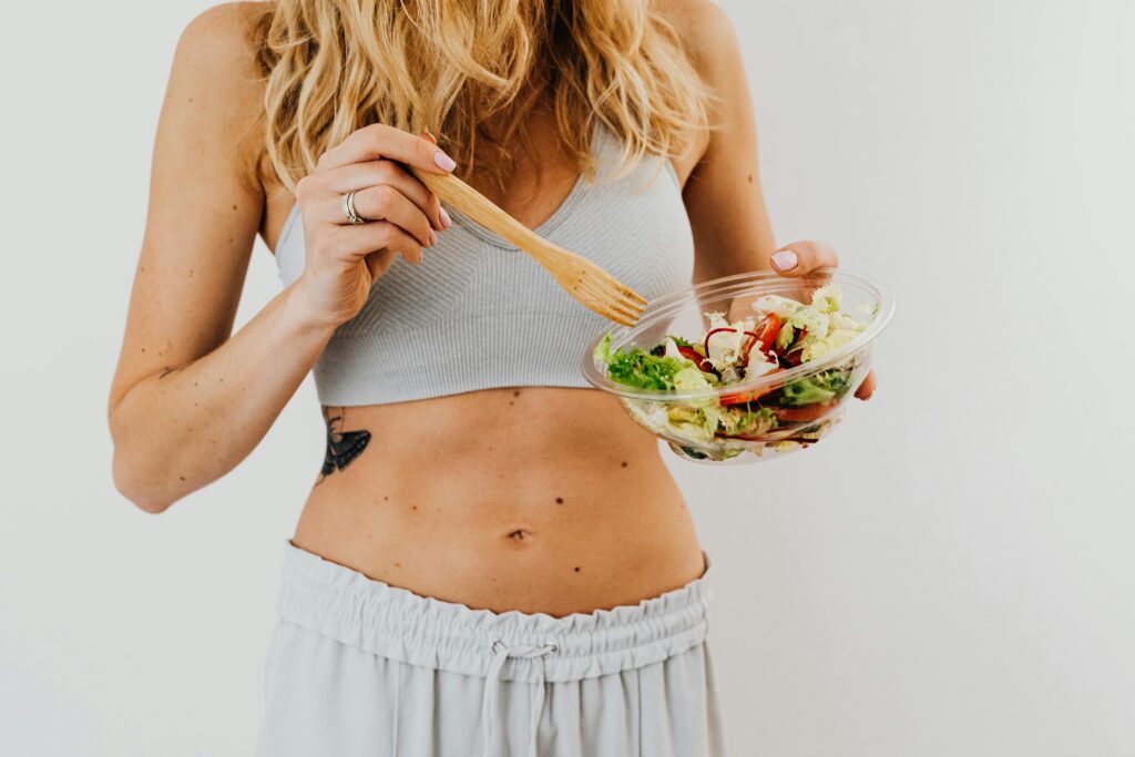 Woman holding a bowl of salad